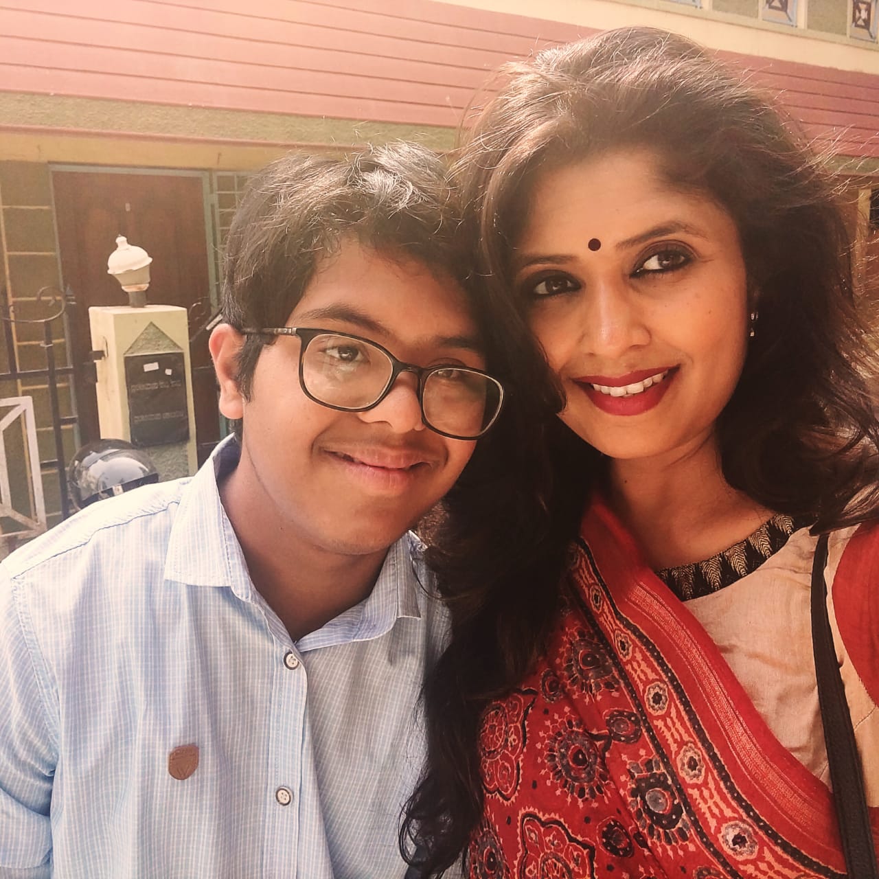 A photo of Purab and Nayana, Purab's mother with her hand on his shoulder