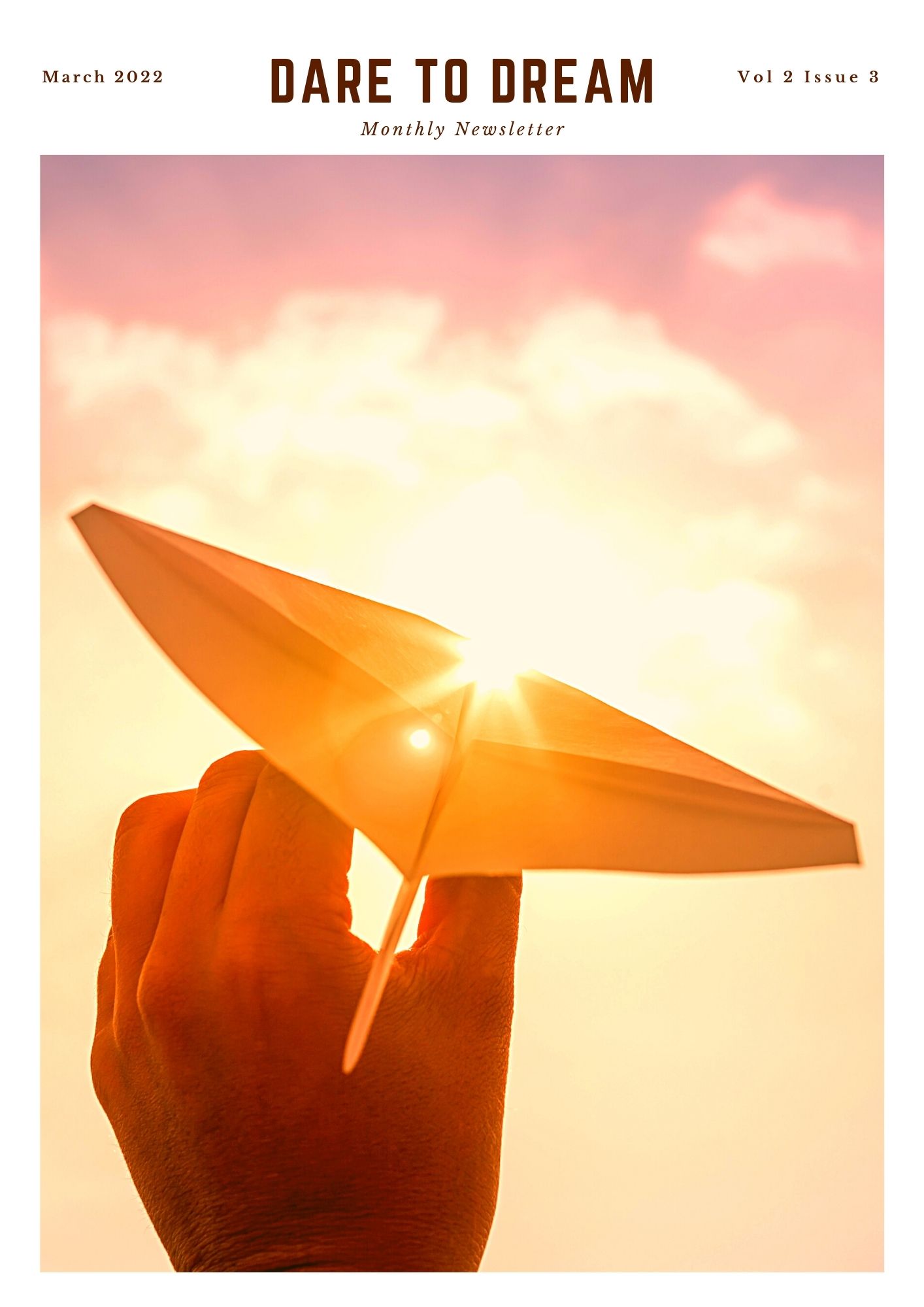 The title Dare to Dream and Monthly Newsletter below that is written in the middle on top, March 2022 on the top left corner and Vol 2 , issue 3 on the top right corner. Below is an image with a hand holding a paper rocket pointed at the sun covering the whole page.