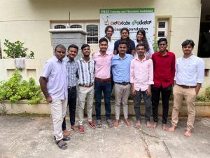 Group of candidates posing for a photo with the trainer, in front of WinVinaya office
