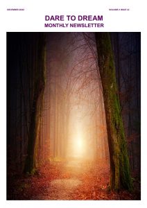 A forest area with a long walk way and the sun is shining brightly and flashing light to the walkway